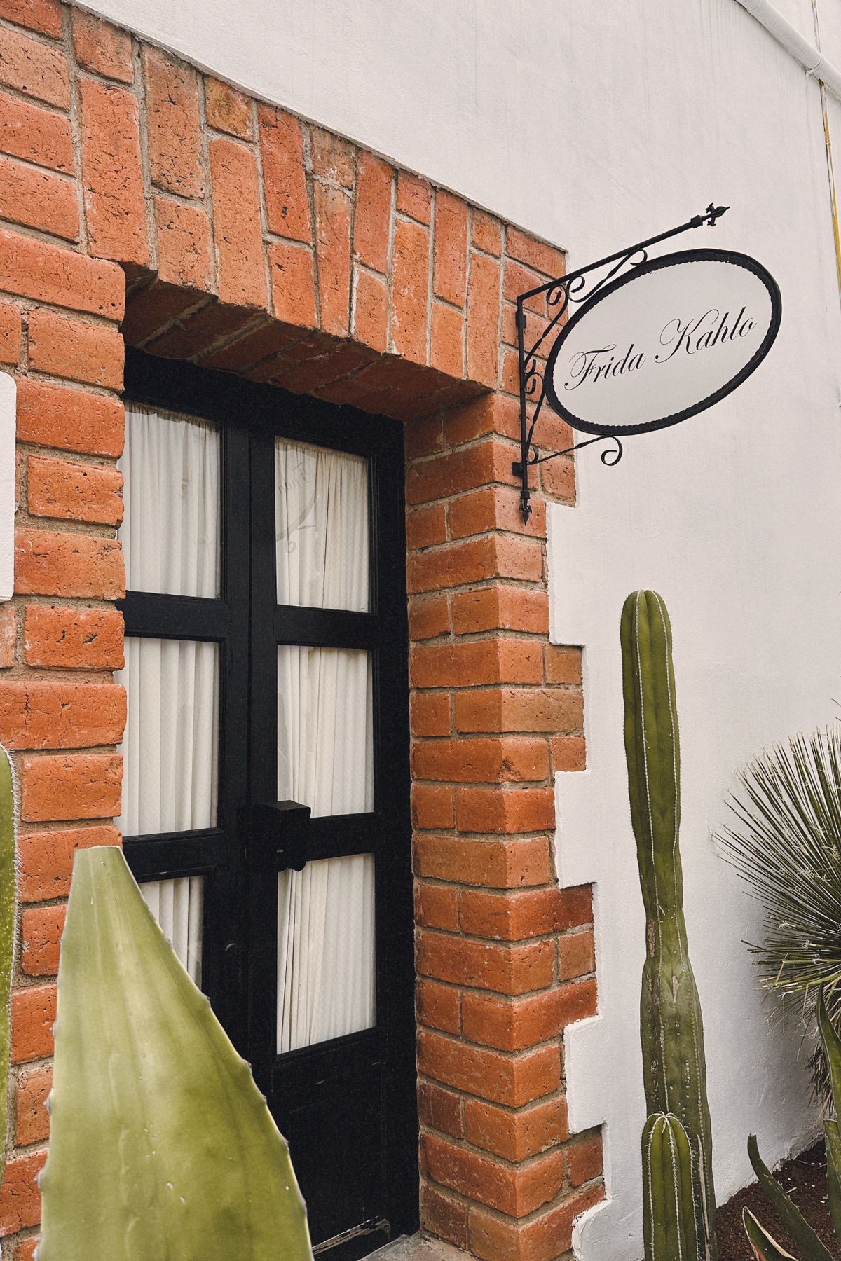 Brick archway and door with plants at a traditional hacienda in Apan, Mexico.