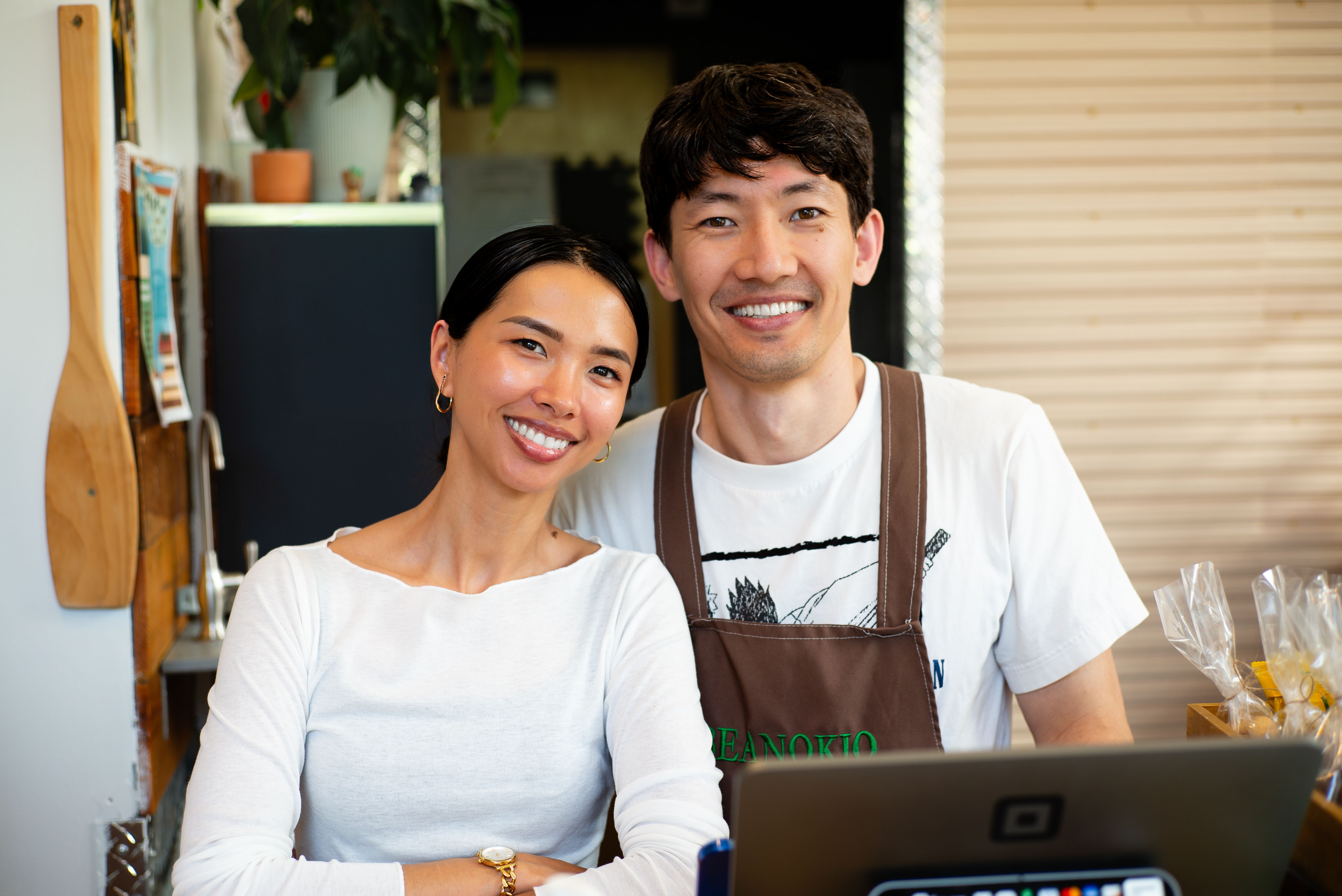 Friendly local cafe owners behind the counter of their business