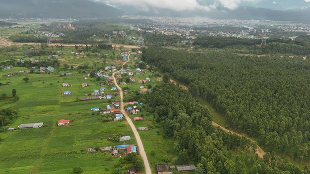 Scenic aerial view of rural Nepal with lush greenery and small villages.