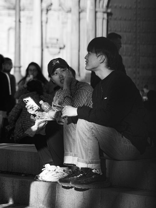 Free A candid black and white photo of people relaxing on steps in Cusco, Peru. Stock Photo