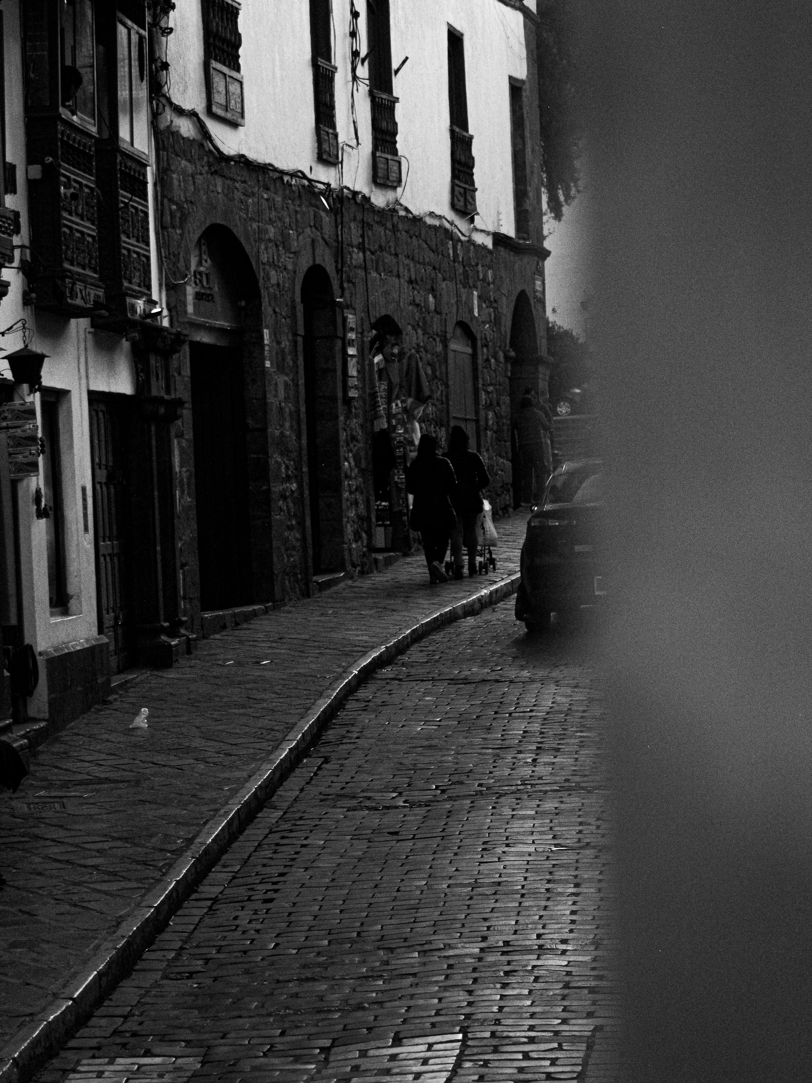 Charming monochrome street view in Cusco, capturing historic architecture and local life.