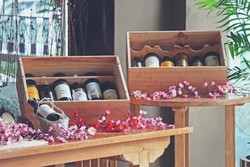 Free stock photo of alcohol bottles, exhibition, flowers