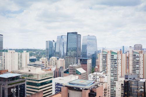 Free Aerial view of Sao Paulo showcasing modern architecture and skyline under a cloudy sky. Stock Photo