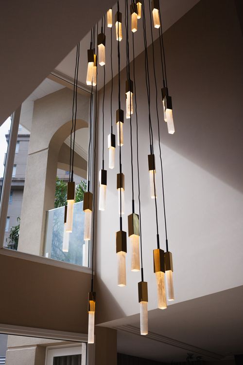 Free Artistic pendant lights cascading in a modern indoor setting. Stock Photo