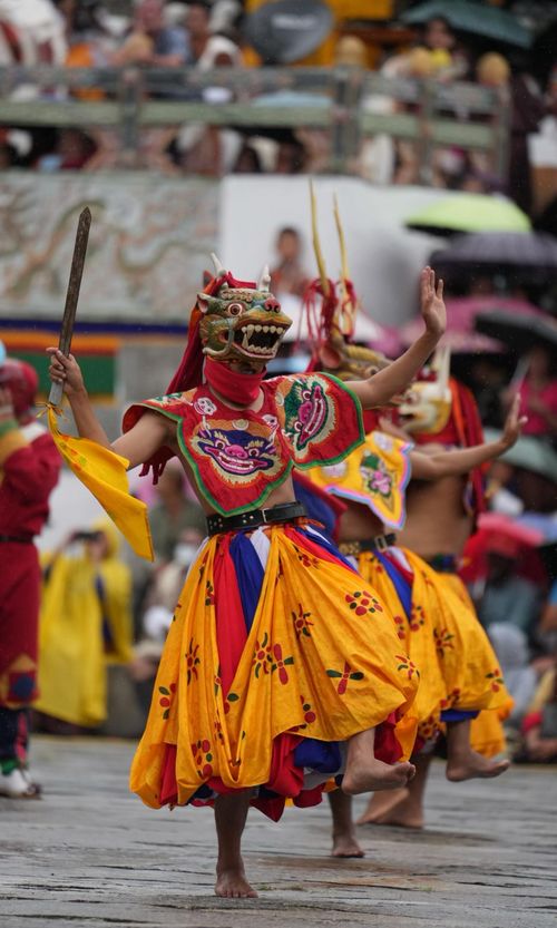 Free Colorful and traditional Bhutanese dance performance with vivid costumes and masks, showcasing cultural heritage. Stock Photo