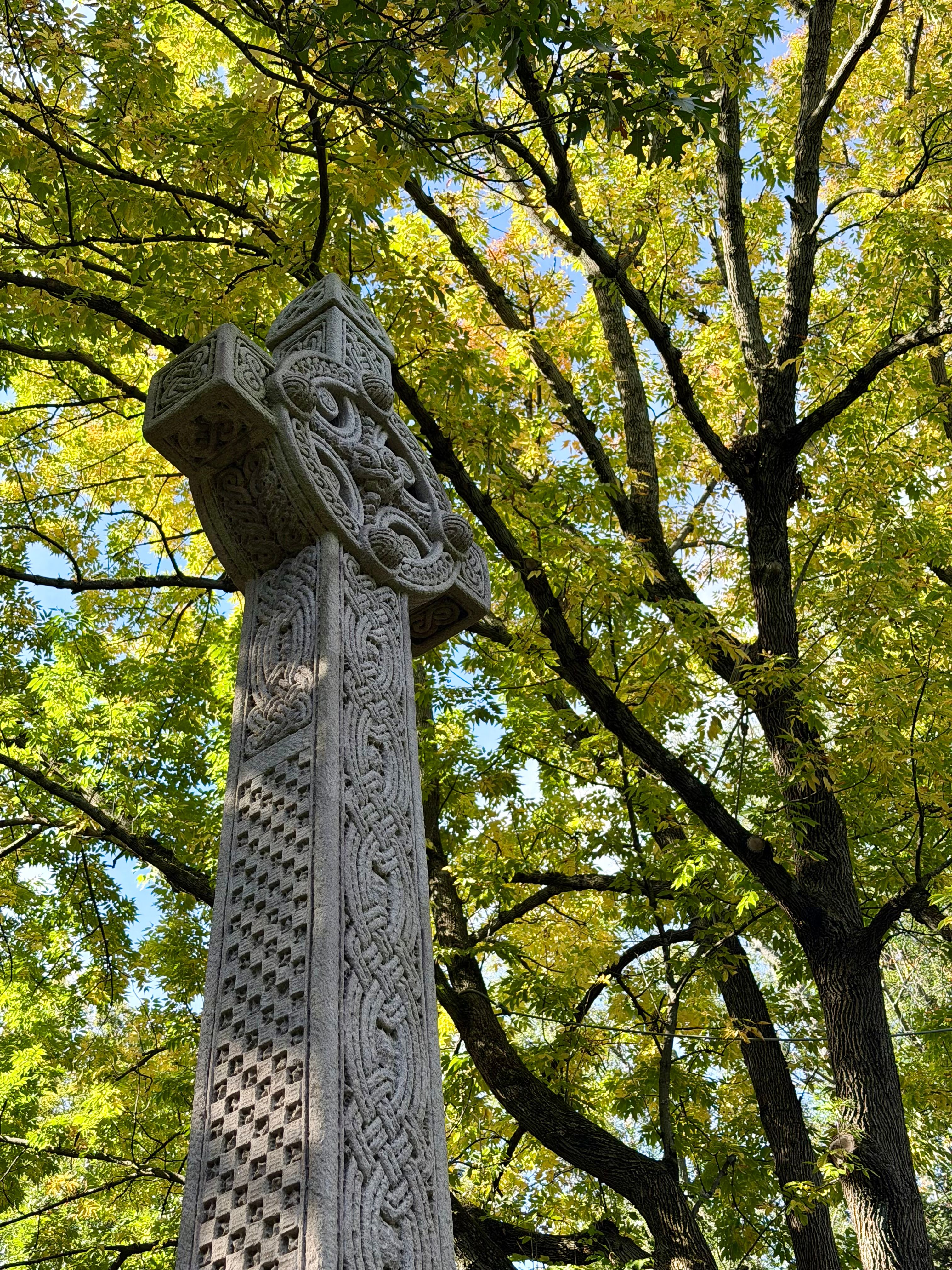 Celtic Cross Under Autumn Trees in Sunlight · Free Stock Photo