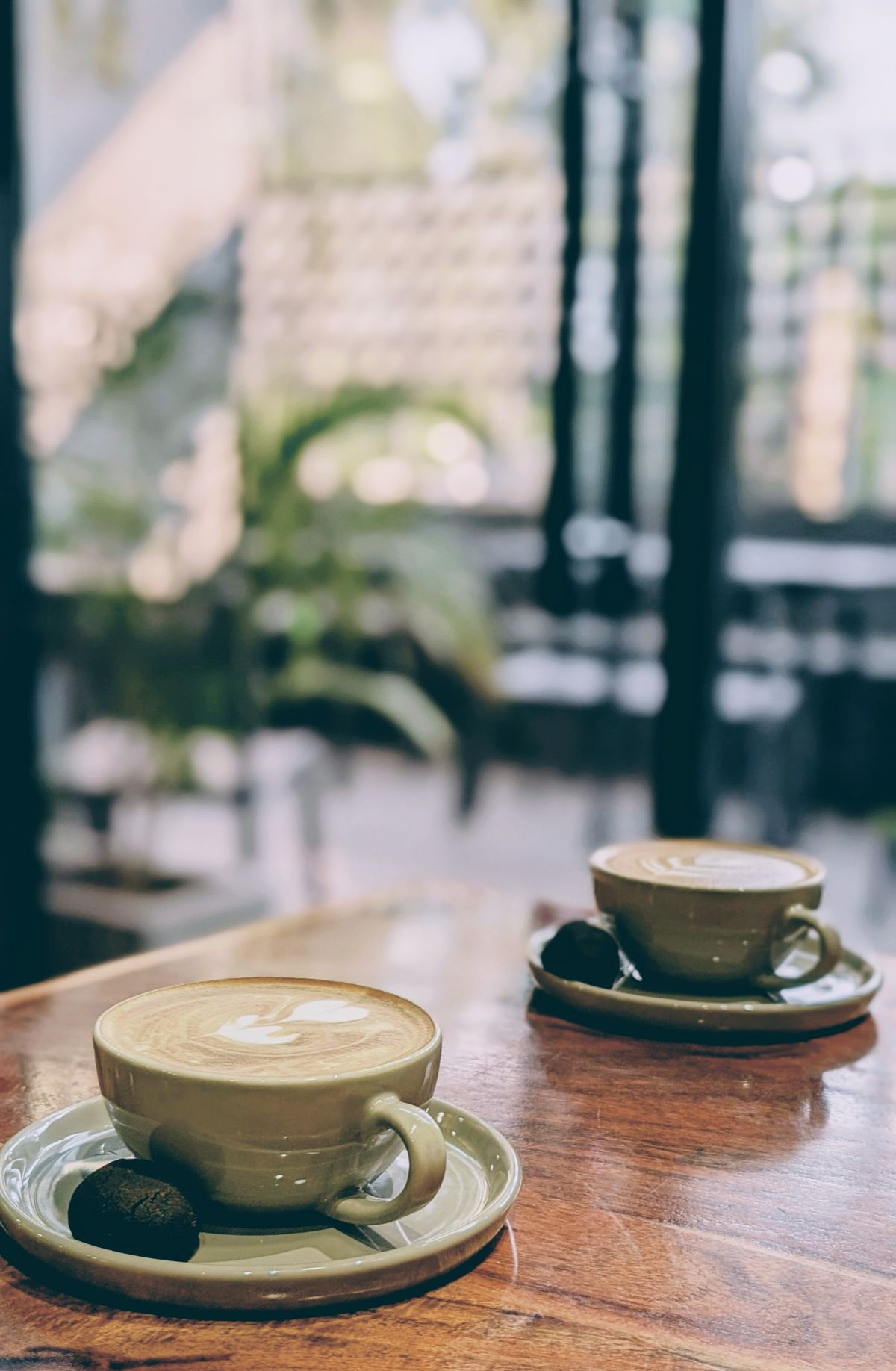 Two warm coffee cups on a table in a cozy cafe