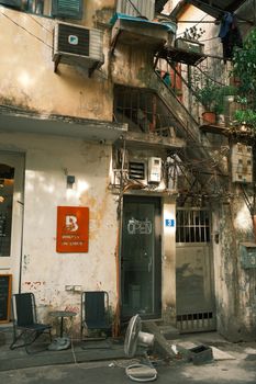 A rustic building facade with urban elements and open signage in Japan.