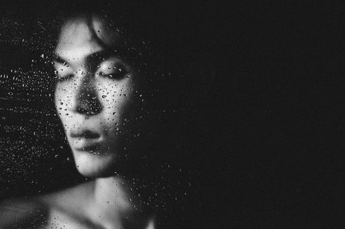 Free Artistic black and white portrait of a person behind water-soaked glass, evoking emotion. Stock Photo