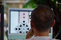 Person Designing Patterns on Computer Screen