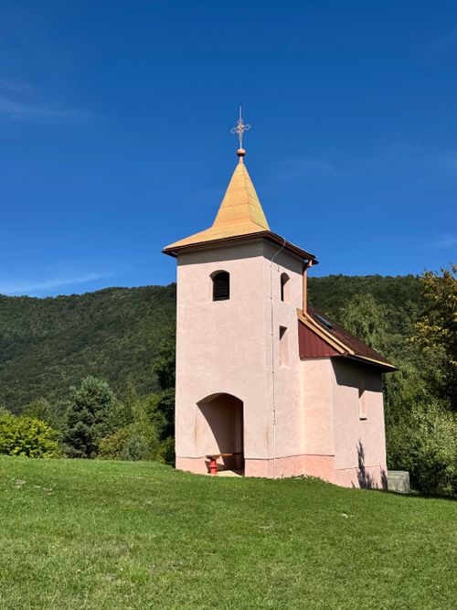 Free Picturesque chapel surrounded by lush greenery in Stari Grad Žumberački, Croatia, under a clear blue sky. Stock Photo