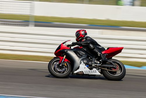 Free A motorcyclist in full gear speedily navigates the Hockenheim race track in Germany on a Yamaha bike. Stock Photo