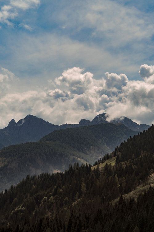 Free Breathtaking view of the Austrian Alps under a dynamic sky with billowing clouds. Stock Photo