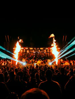 Vibrant night concert with a crowd, lights, and fire effects. Perfect for festival themes.