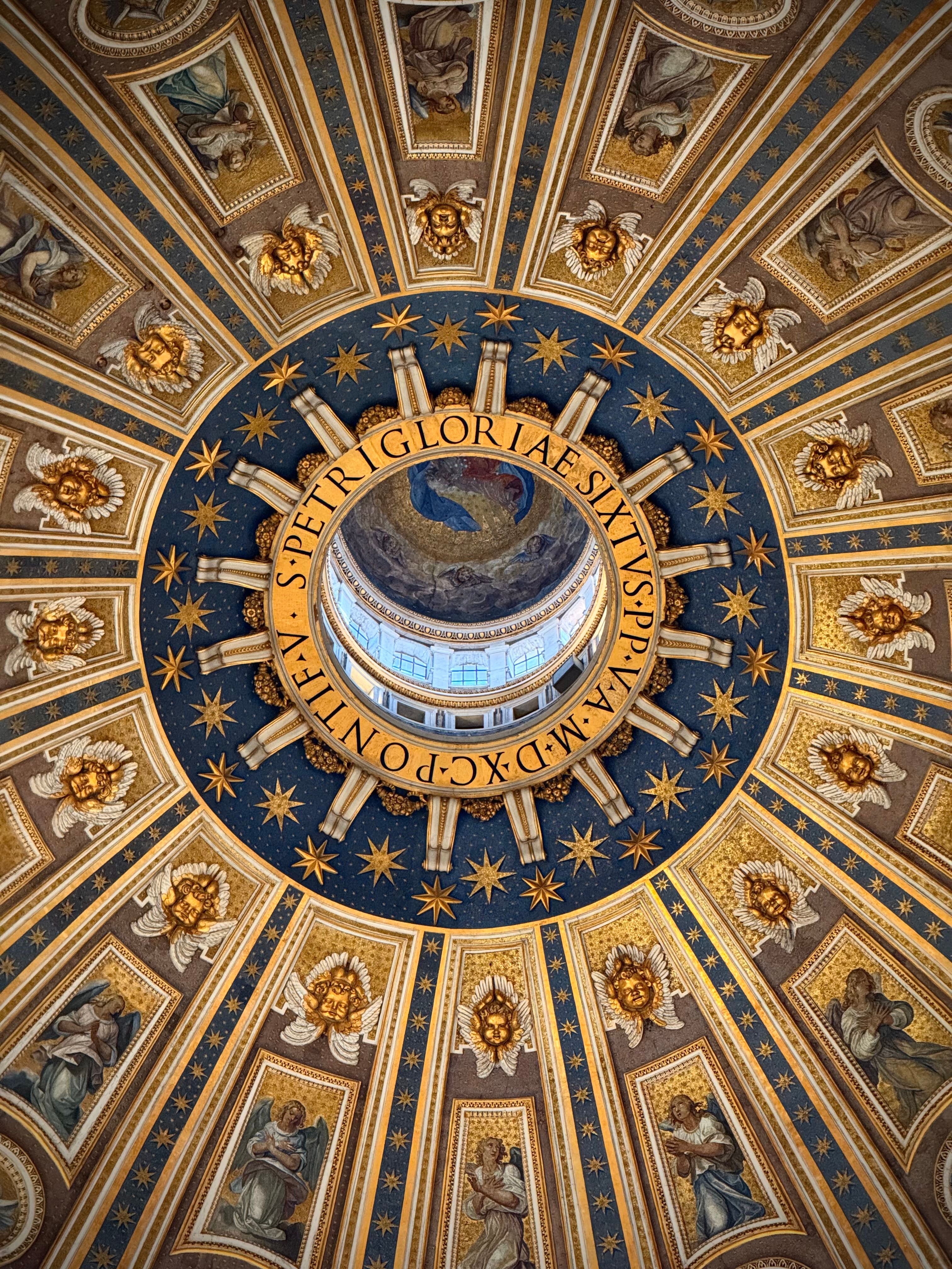 Intricate view inside St. Peter's Basilica showcasing the ornate dome's architecture.