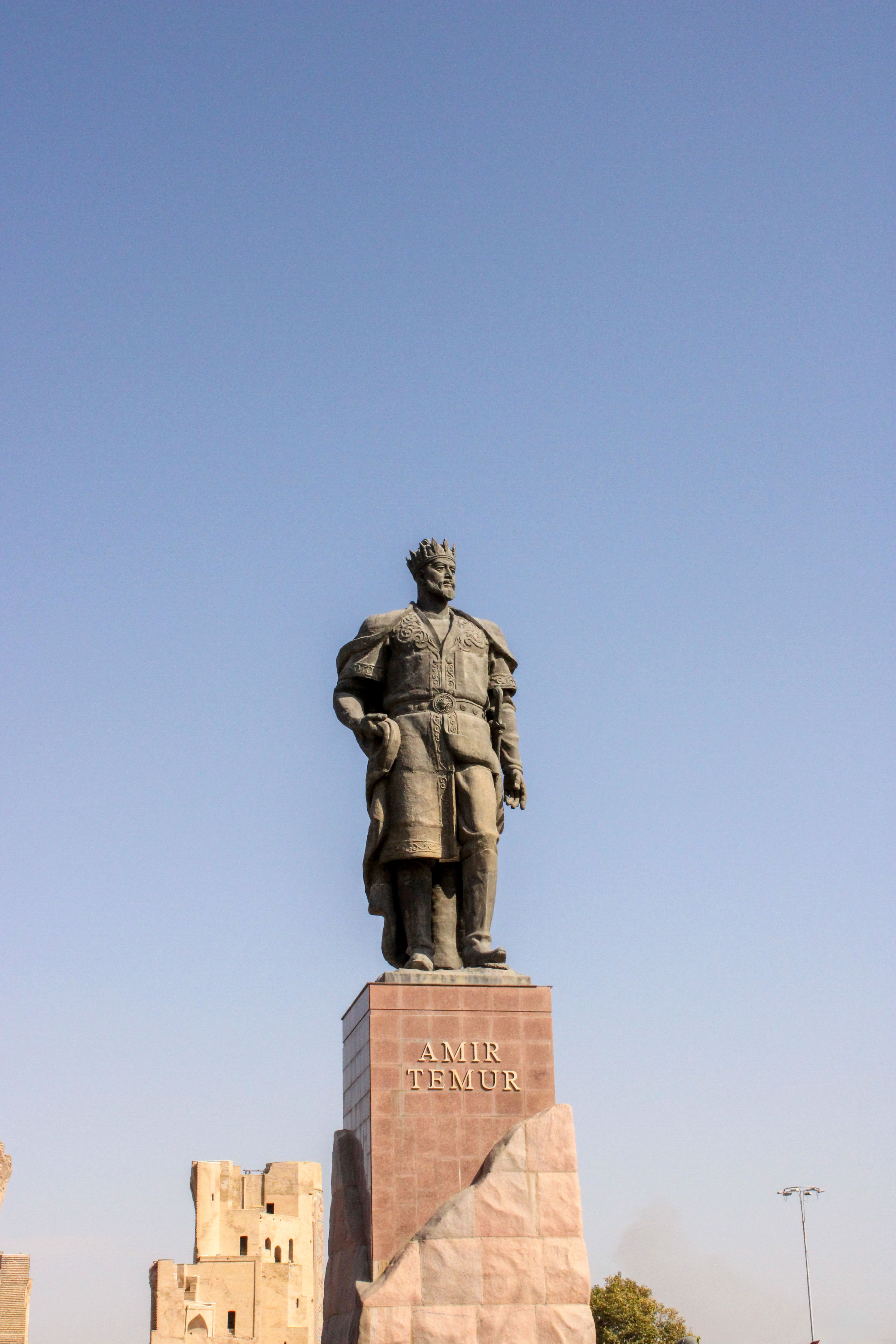 Stately monument of Amir Temur against a clear blue sky, highlighting his historic legacy.