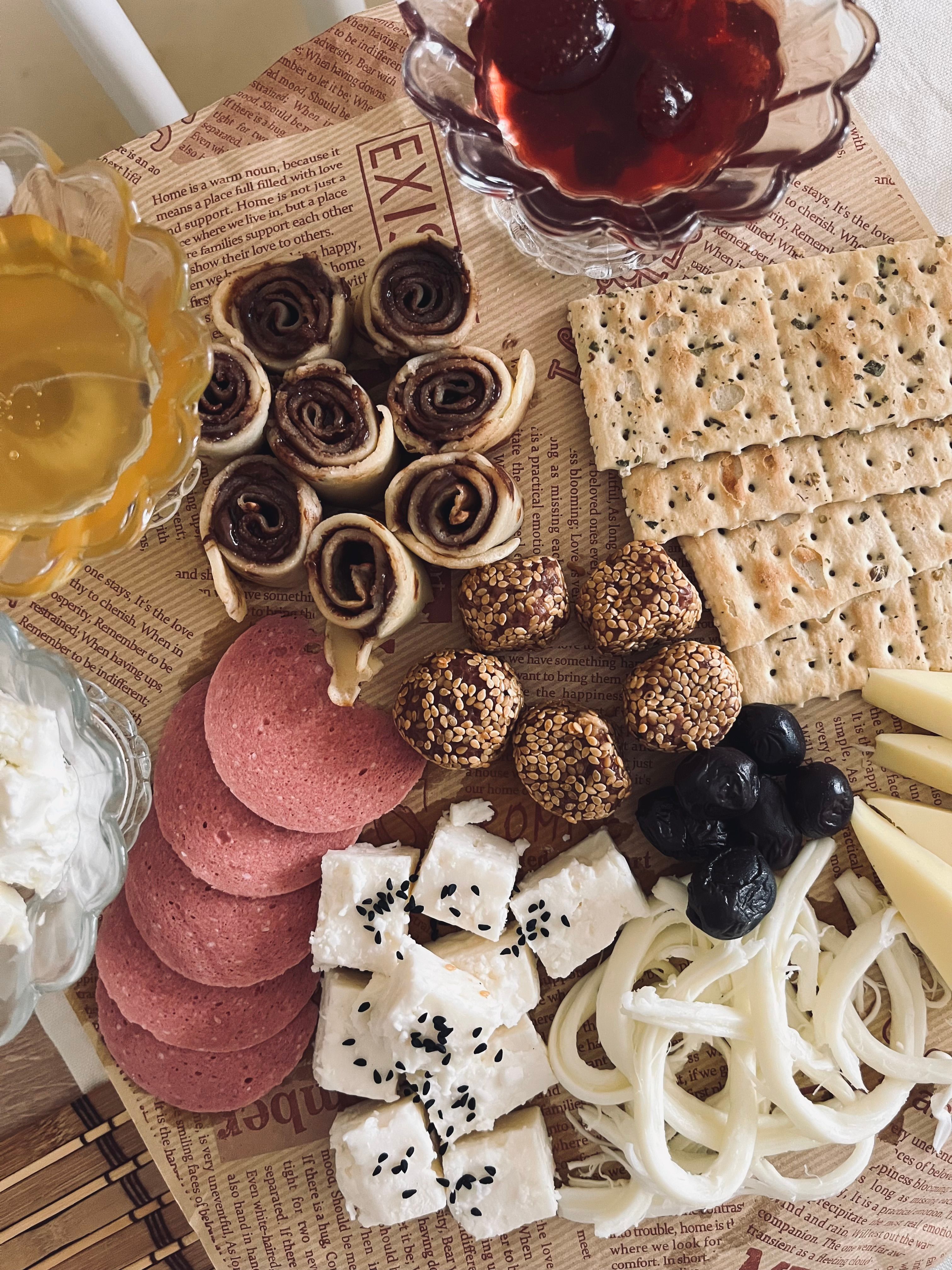 Breakfast platter with cheese, crackers, and pastries