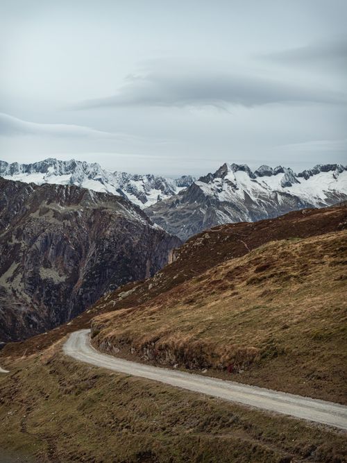 Free A winding road through the Swiss Alps in Andermatt offers a dramatic winter landscape. Stock Photo