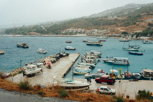 Free Picturesque harbor scene in Zakynthos, Greece, featuring boats and serene waters. Stock Photo