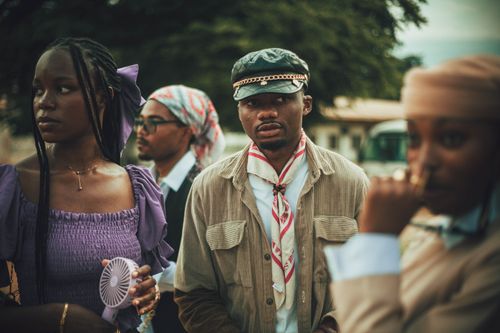 Free Fashionable young adults gathered outdoors with vintage style clothing and accessories. Stock Photo
