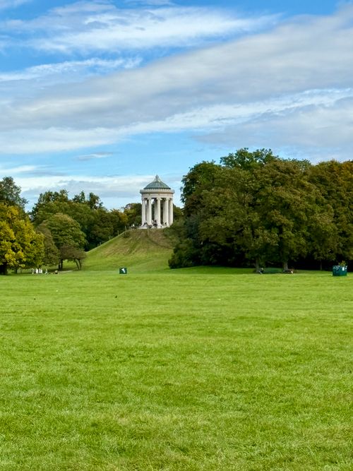 Free Scenic view of Monopteros temple in Munich's English Garden under a blue sky. Stock Photo