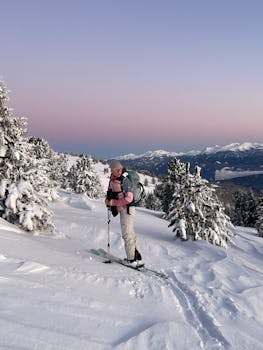 Active woman skiing through fresh snow in Styria, Austria's breathtaking winter landscape at dawn.