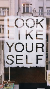 A motivational shop window sign saying 'Look Like Yourself' in Vienna, Austria.
