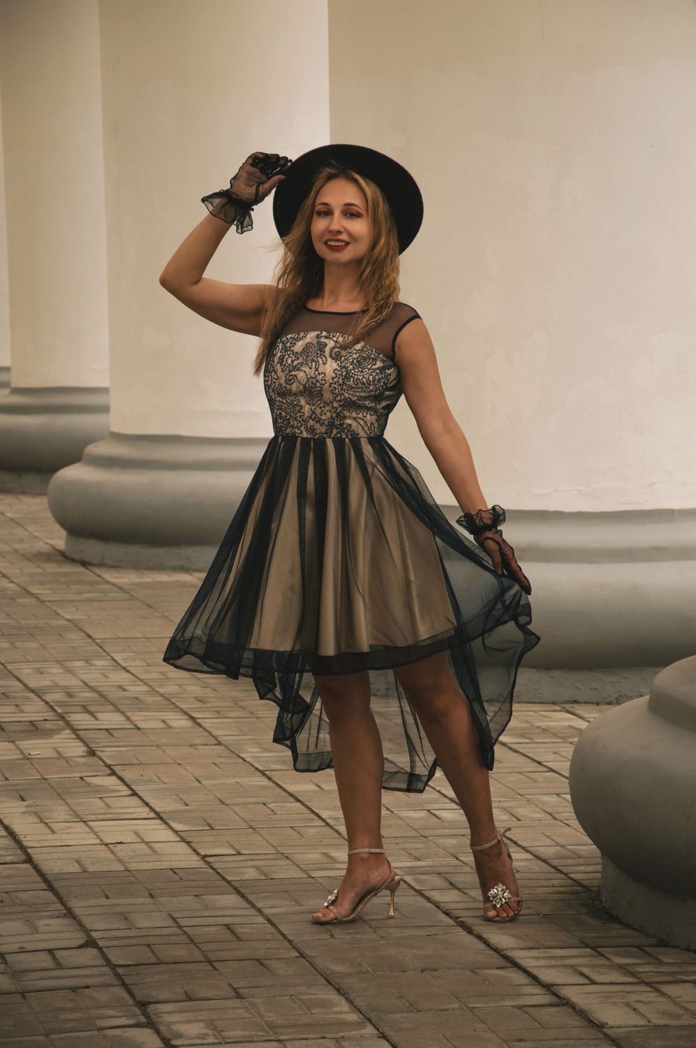 Elegant Woman Posing Outdoors in Stylish Dress · Free Stock Photo