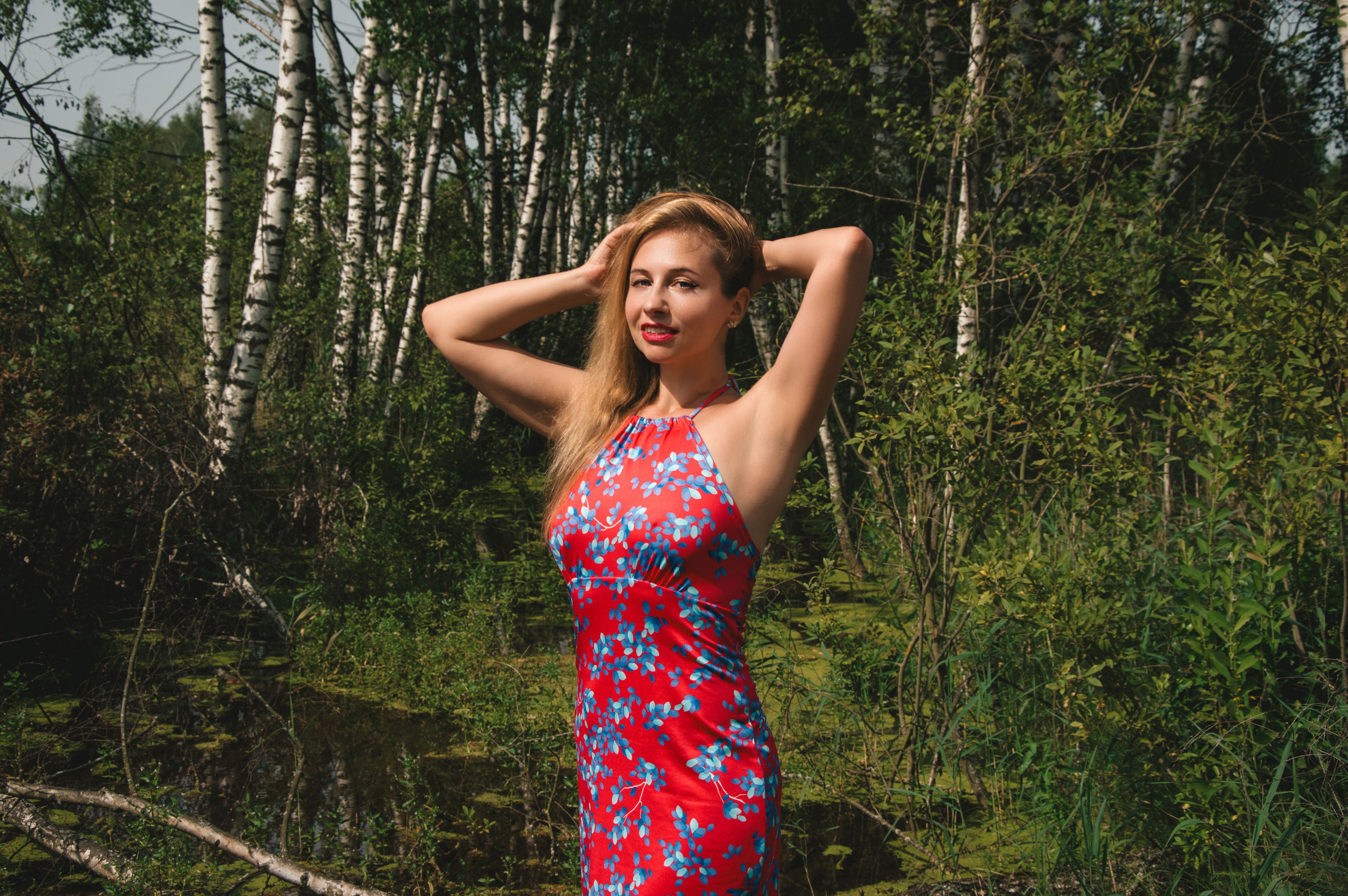 Woman in Floral Dress Standing in Forest · Free Stock Photo