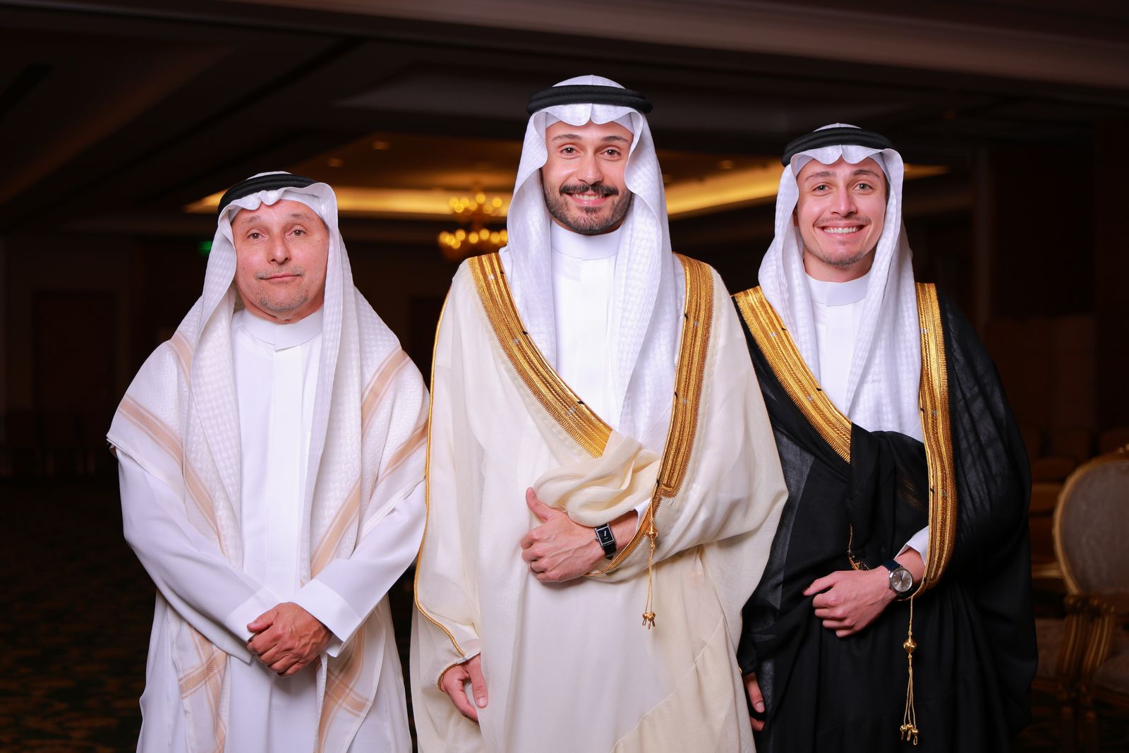 Three men in traditional thobes