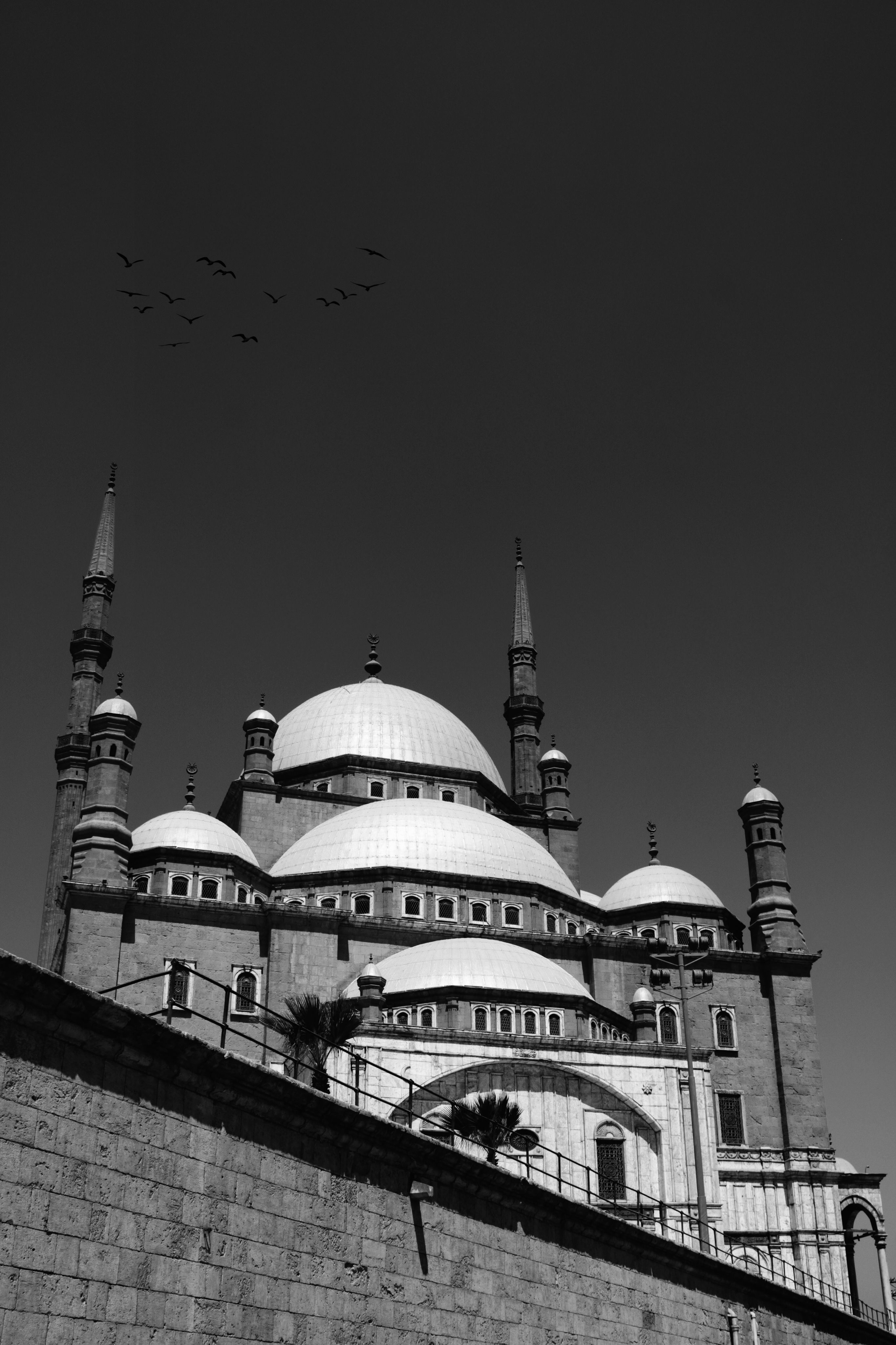 Black and white image of a historic mosque with Islamic architecture in Cairo.
