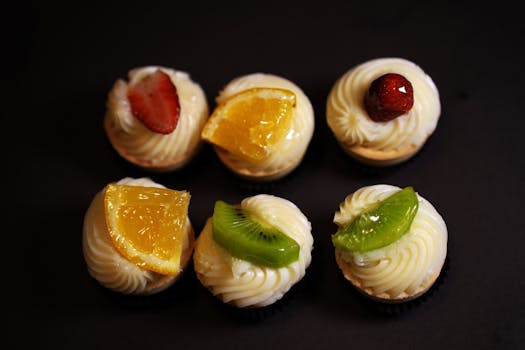 Indulge in these beautiful fruit-topped cupcakes, perfect for any occasion.