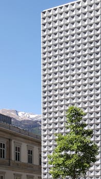 A striking brutalist building stands tall against a clear sky in Chur, Switzerland.