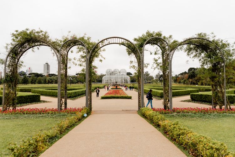 Arched walkway at Curitiba's Jardim Botânico leading toward the Art Nouveau greenhouse — the southern Brazilian city's most recognizable landmark.