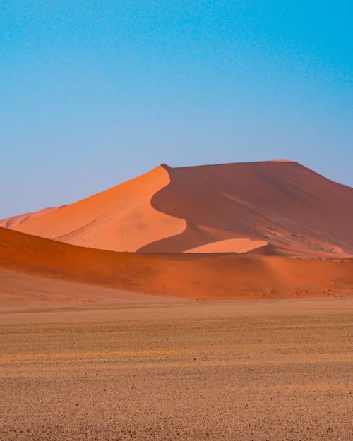 Free Beautiful golden sand dunes under blue sky in Namib Desert, Namibia. Stock Photo