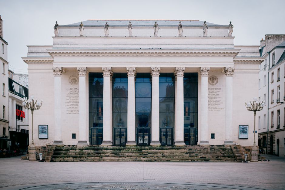 Front view of the historic neoclassical opera house in Nantes, showcasing grand Corinthian columns.