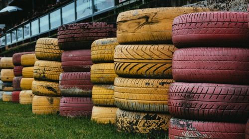 Free Stacks of colorful red and yellow tires arranged outdoors, perfect for recycling themes. Stock Photo