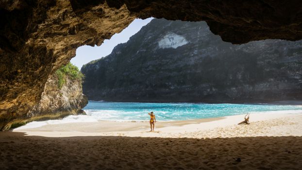 A picturesque view of the sandy beach and turquoise waters at Kelingking Beach, Bali.