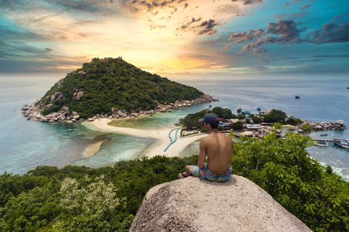 Free Man admiring breathtaking sunset view of Koh Nang Yuan Island in Thailand. Stock Photo