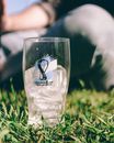 Ice-filled FIFA World Cup 2022 glass on grass in Buenos Aires, outdoor setting.