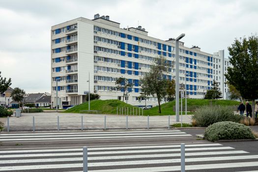 Modern apartment building with greenery in Calais, France, highlighting urban living.