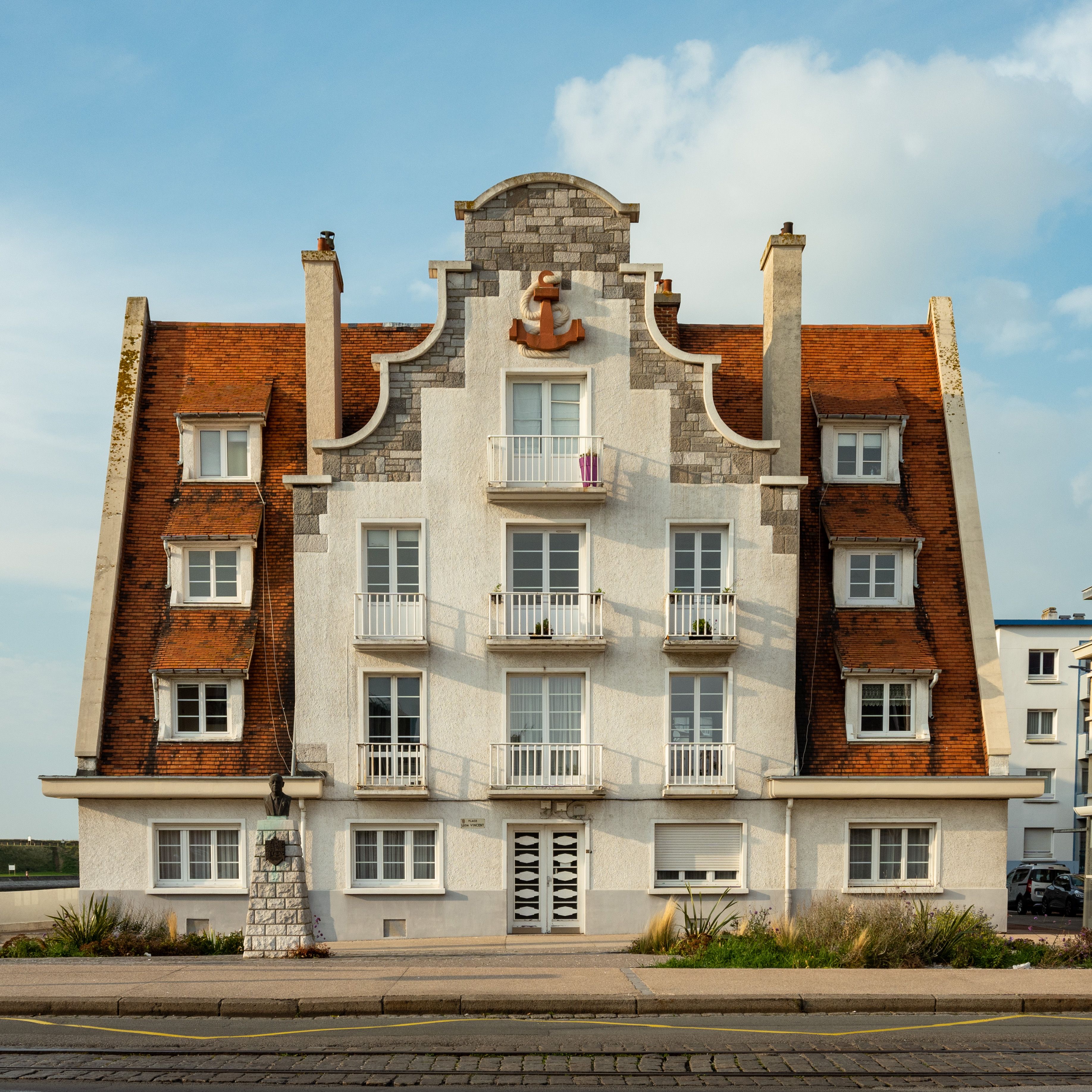 Beautiful historic building in Calais, France with distinct red roof and classic architecture.