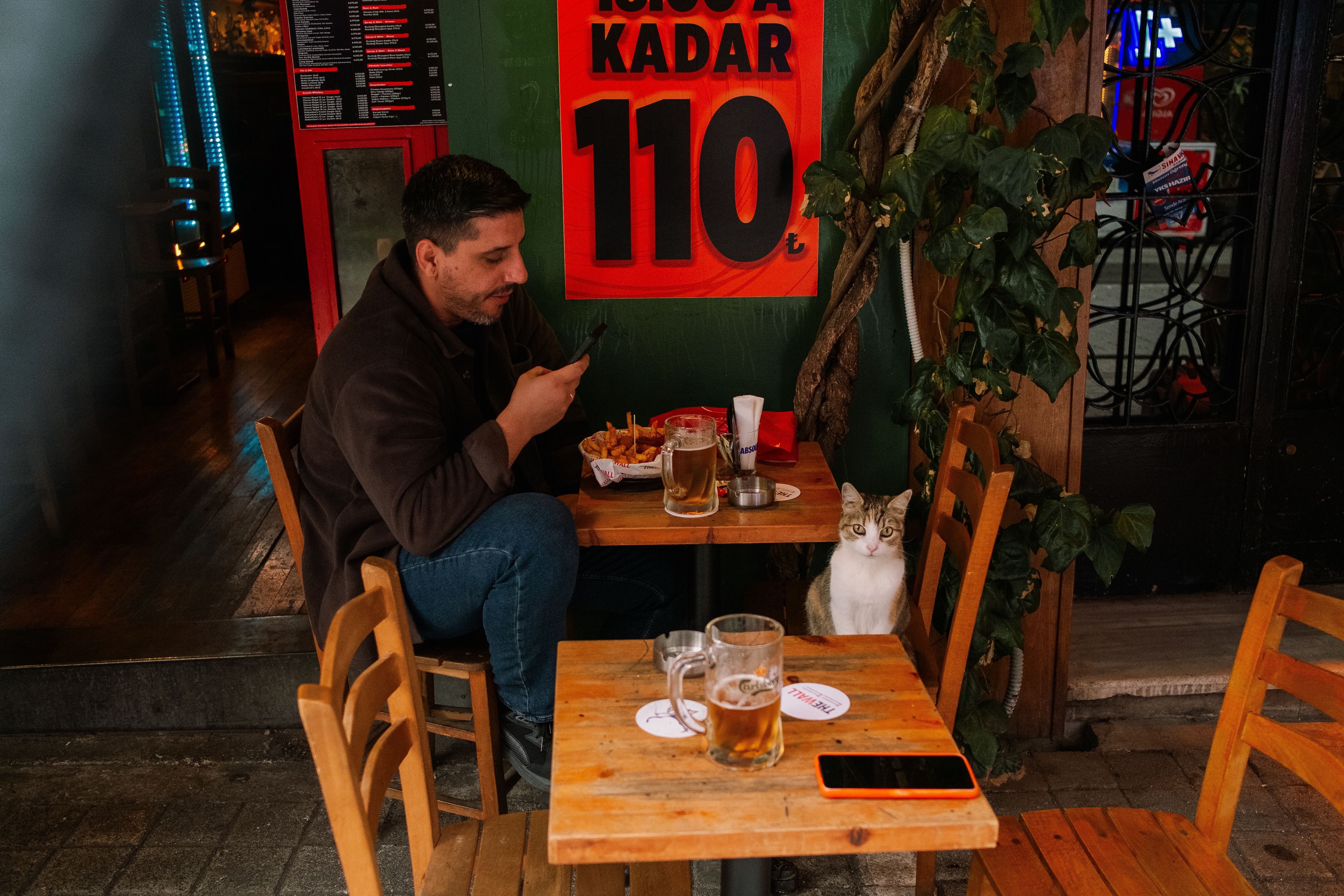 A cup of espresso and a glass of local Croatian beer on a cafe table in Croatia.