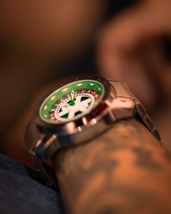 Angled macro of a green bezel and red-and-white inner ring — Alef Morais on Pexels