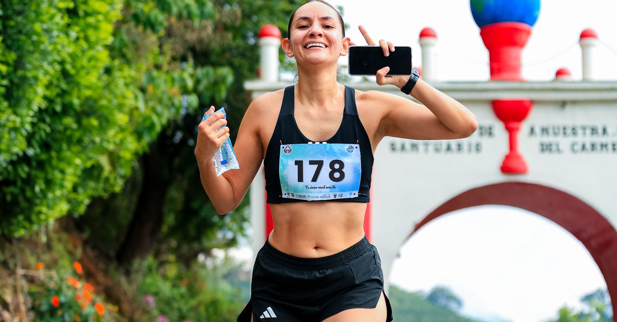 Smiling Runner Smiling Female Runner in Outdoor Race Event · Free Stock Photo