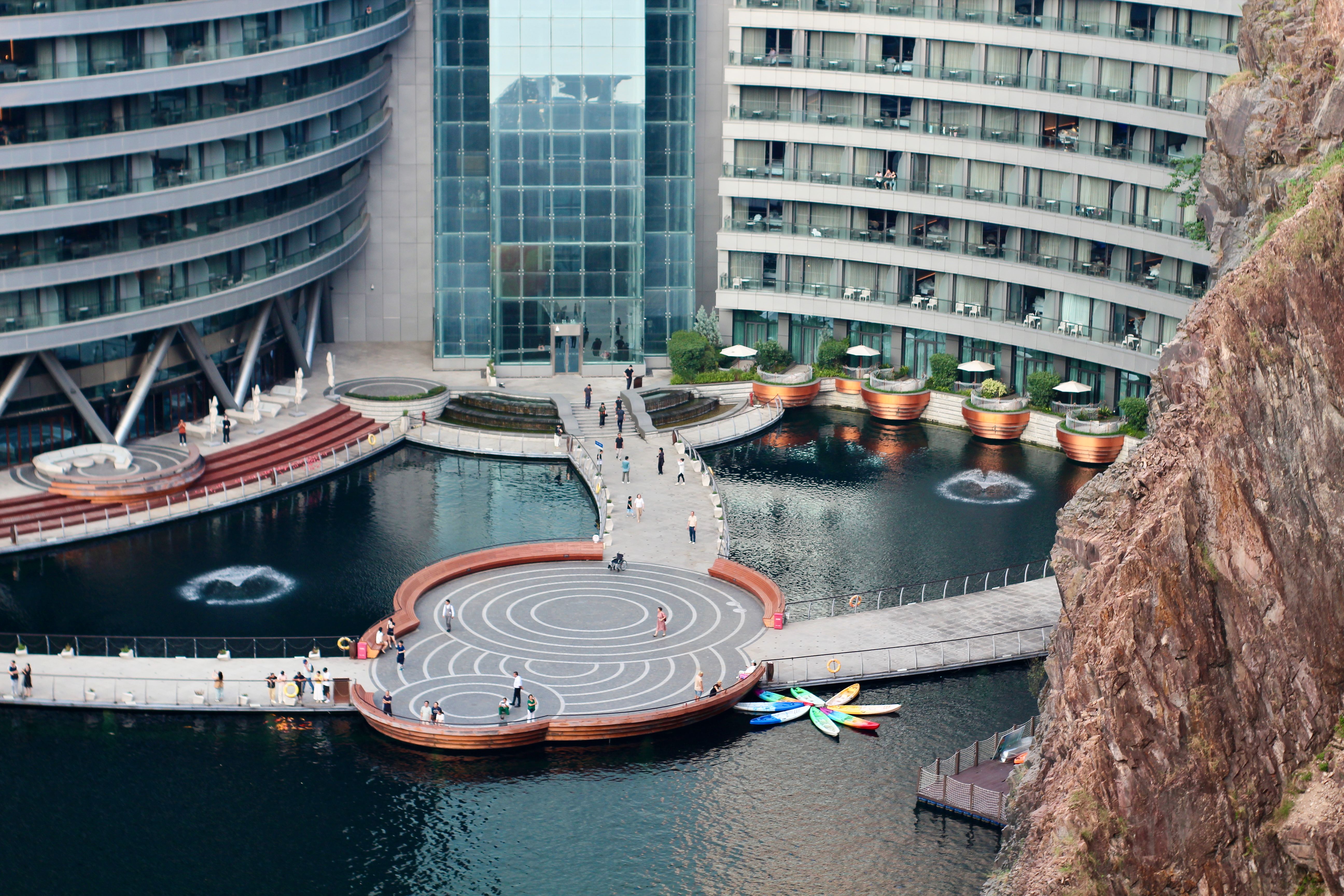 Modern Quarry Hotel with Circular Walkway and Kayaks · Free Stock Photo