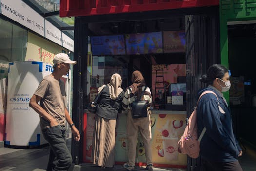 People walk and shop at a vibrant street stall in Bukit Bintang, Kuala Lumpur.