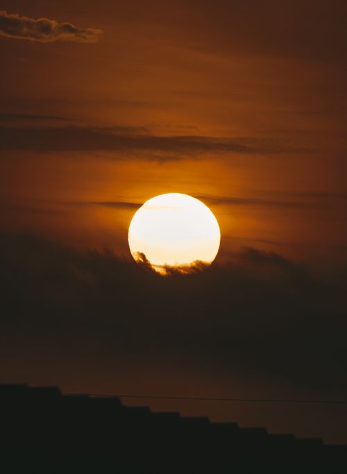 Free Captivating view of the sun setting over Guayaquil, Ecuador, with vibrant orange skies. Stock Photo