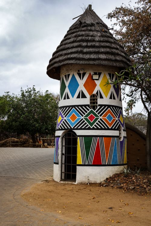 Free Colorful Ndebele tower showcasing traditional African art and architecture outdoors. Stock Photo