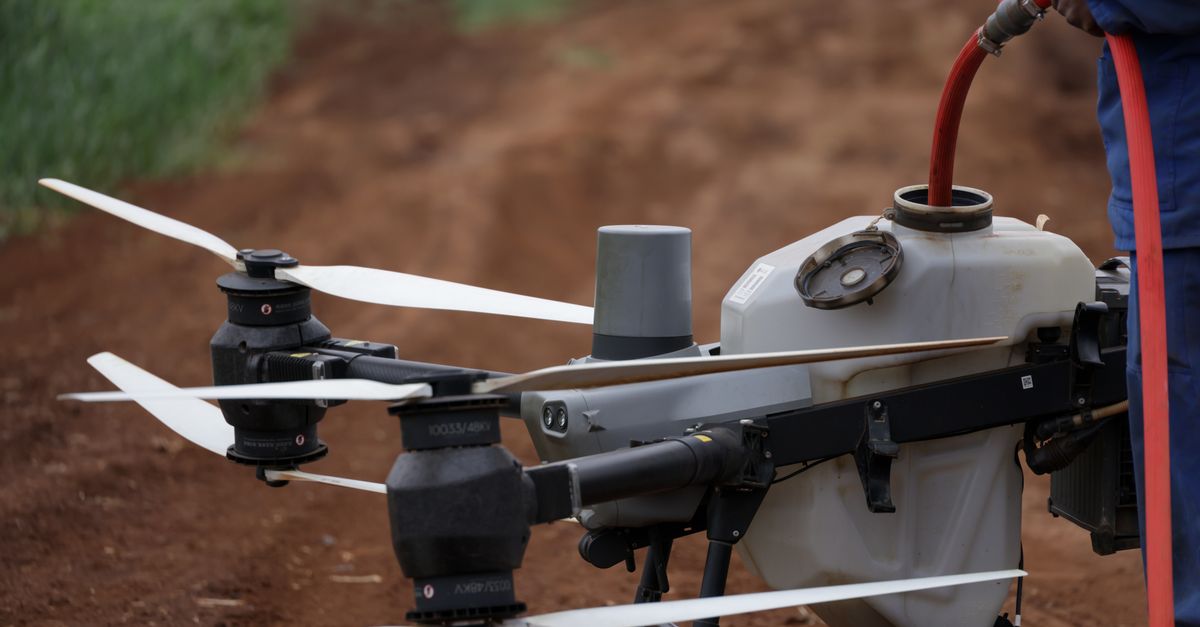 Close-up view of a drone being filled with liquid for agricultural purposes.